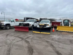 Commercial snow removal trucks and plow equipment prepared for winter service