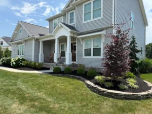 Front yard landscaping with fresh mulch beds, shrubs, and clean edging around home