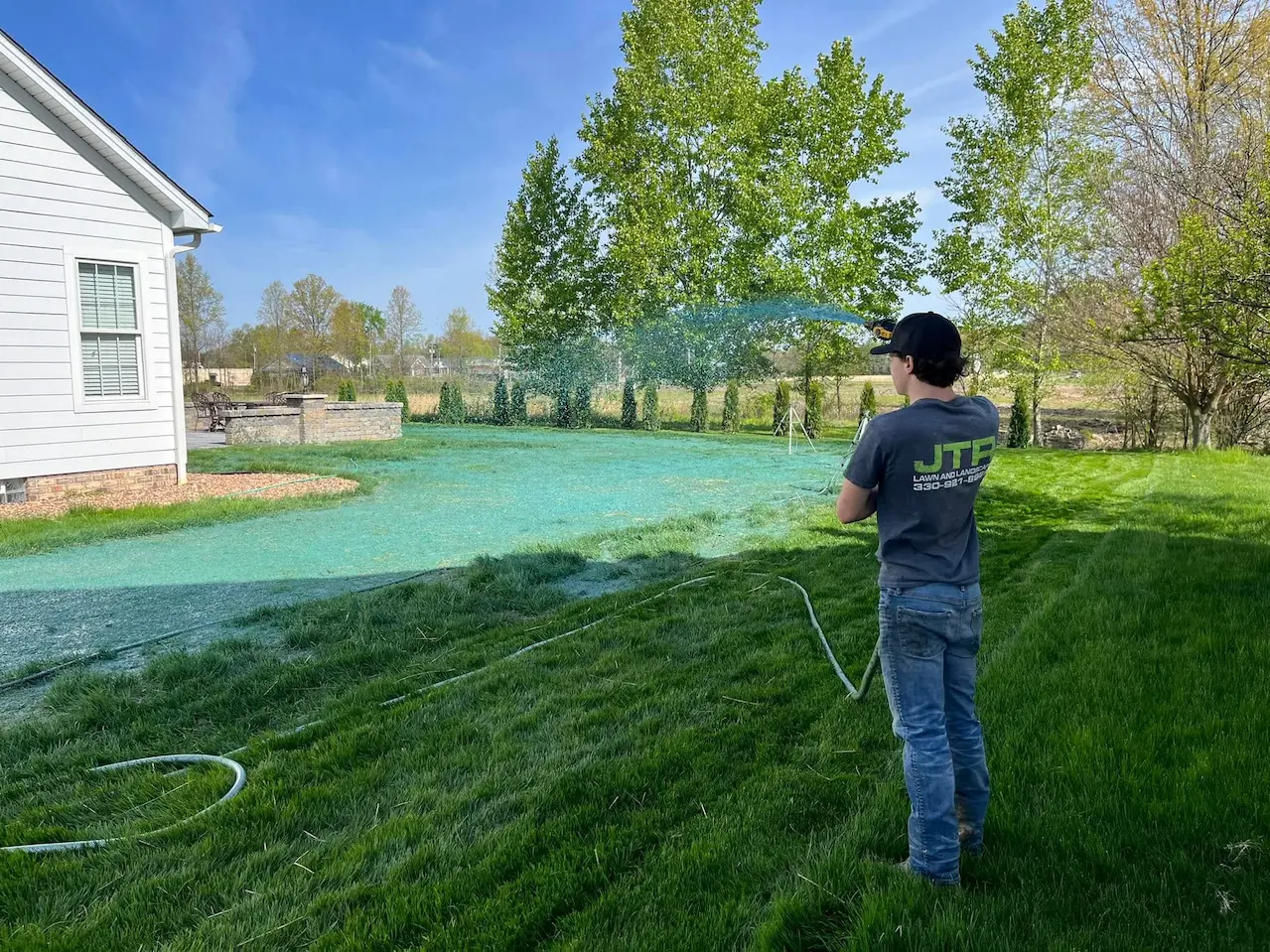 Hydroseeding a new lawn installation with professional equipment at a residential property in Canfield, Ohio