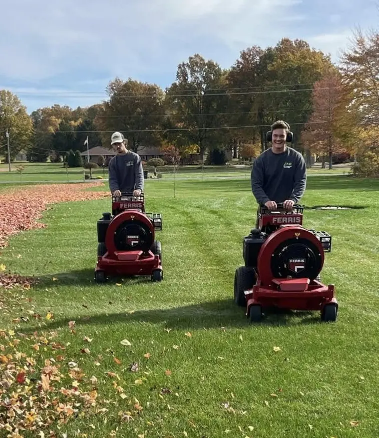 JTR Lawn & Landscape team performing fall leaf cleanup on a residential lawn