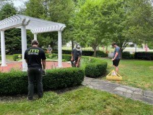 Landscaping team performing hedge trimming and property maintenance