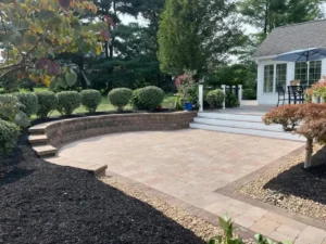 Backyard patio with retaining wall and landscaped beds after installation