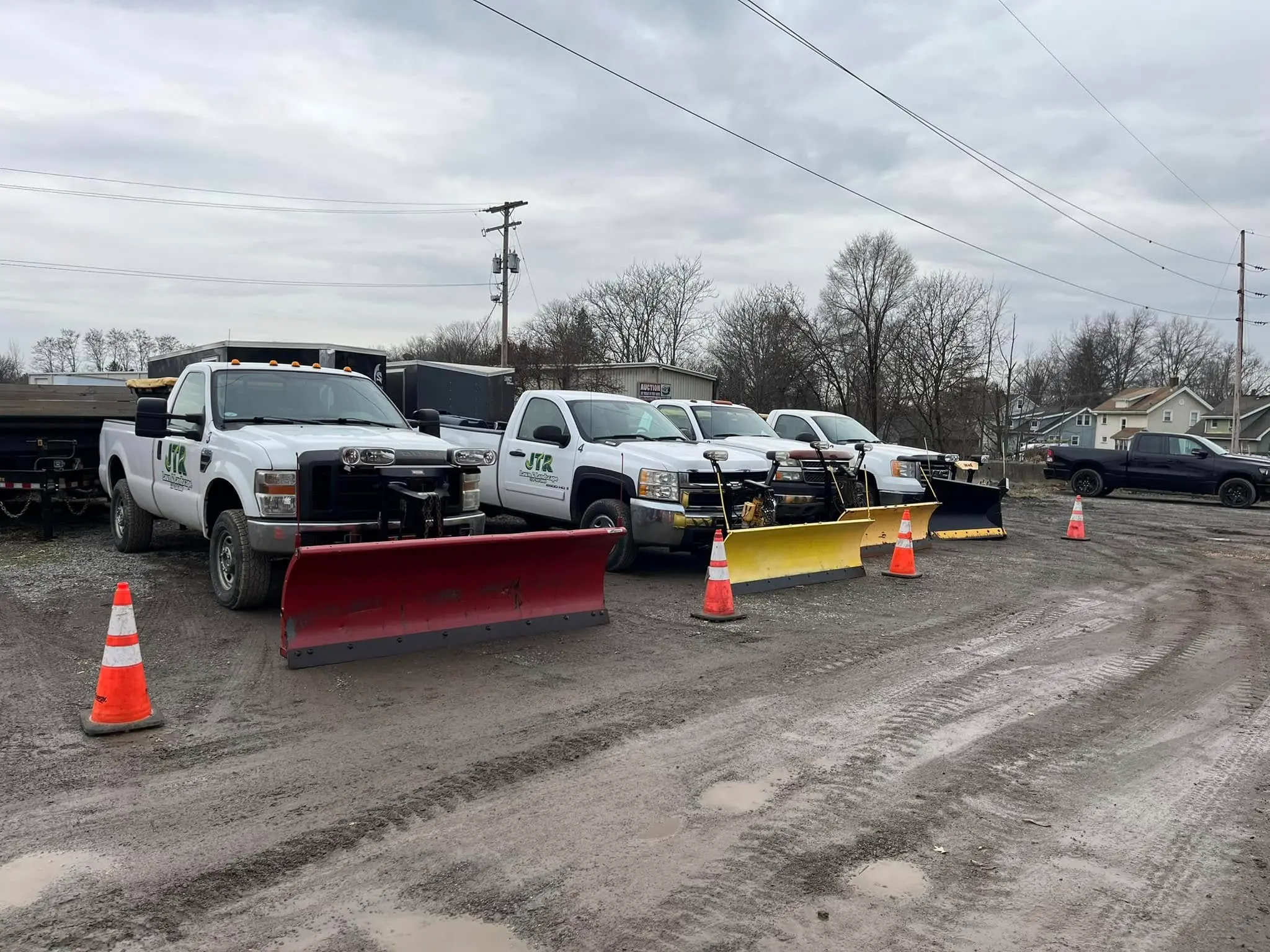 Snow plow trucks lined up and ready for commercial snow removal service